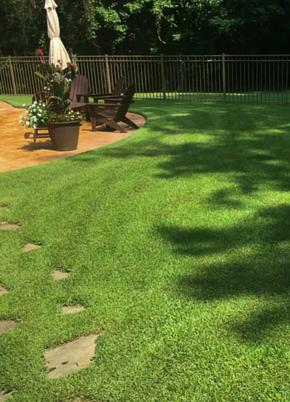 Neatly manicured TruGreen lawn with patio set